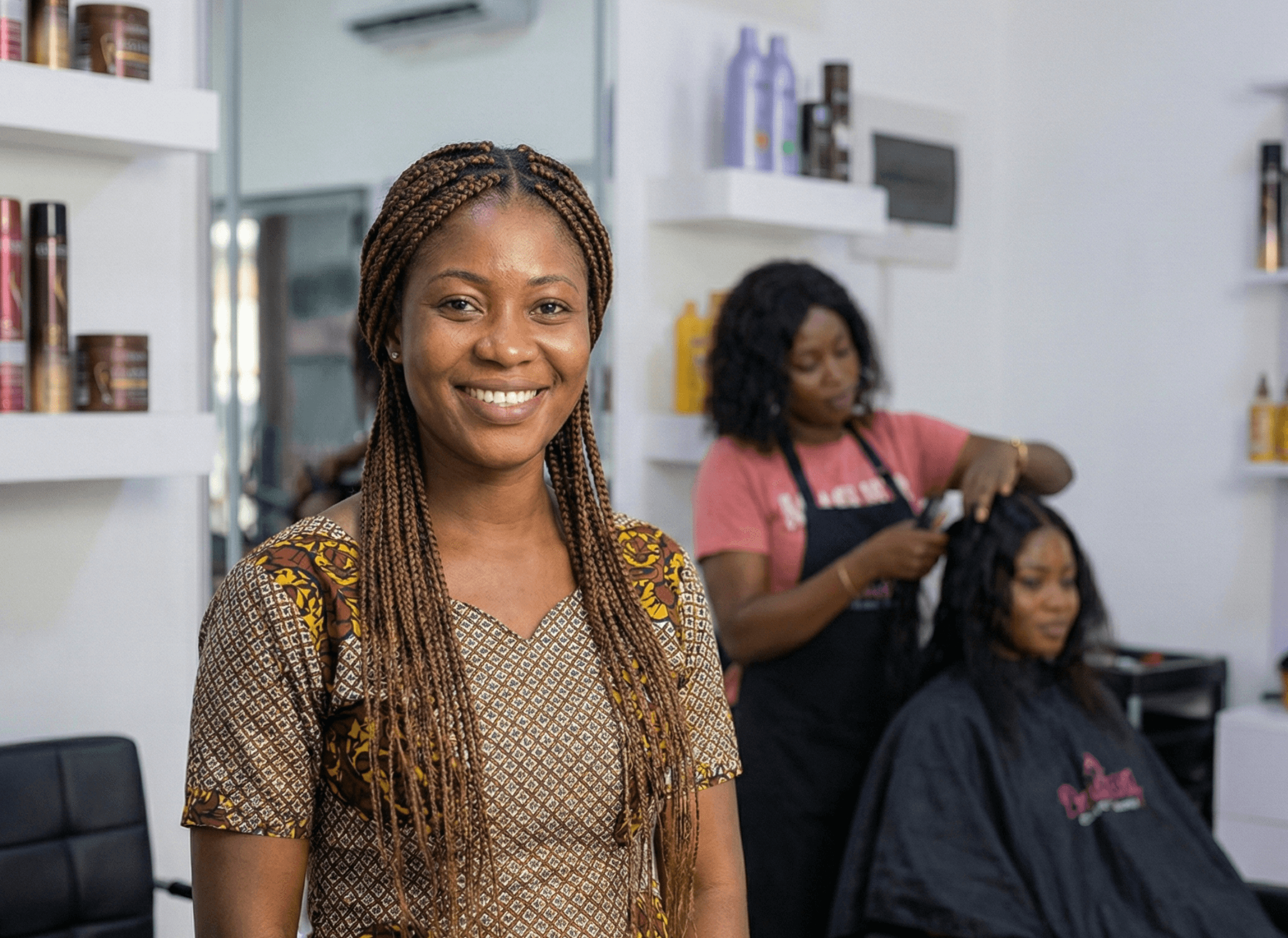 Confident salon owner presenting her finished work to a satisfied customer.